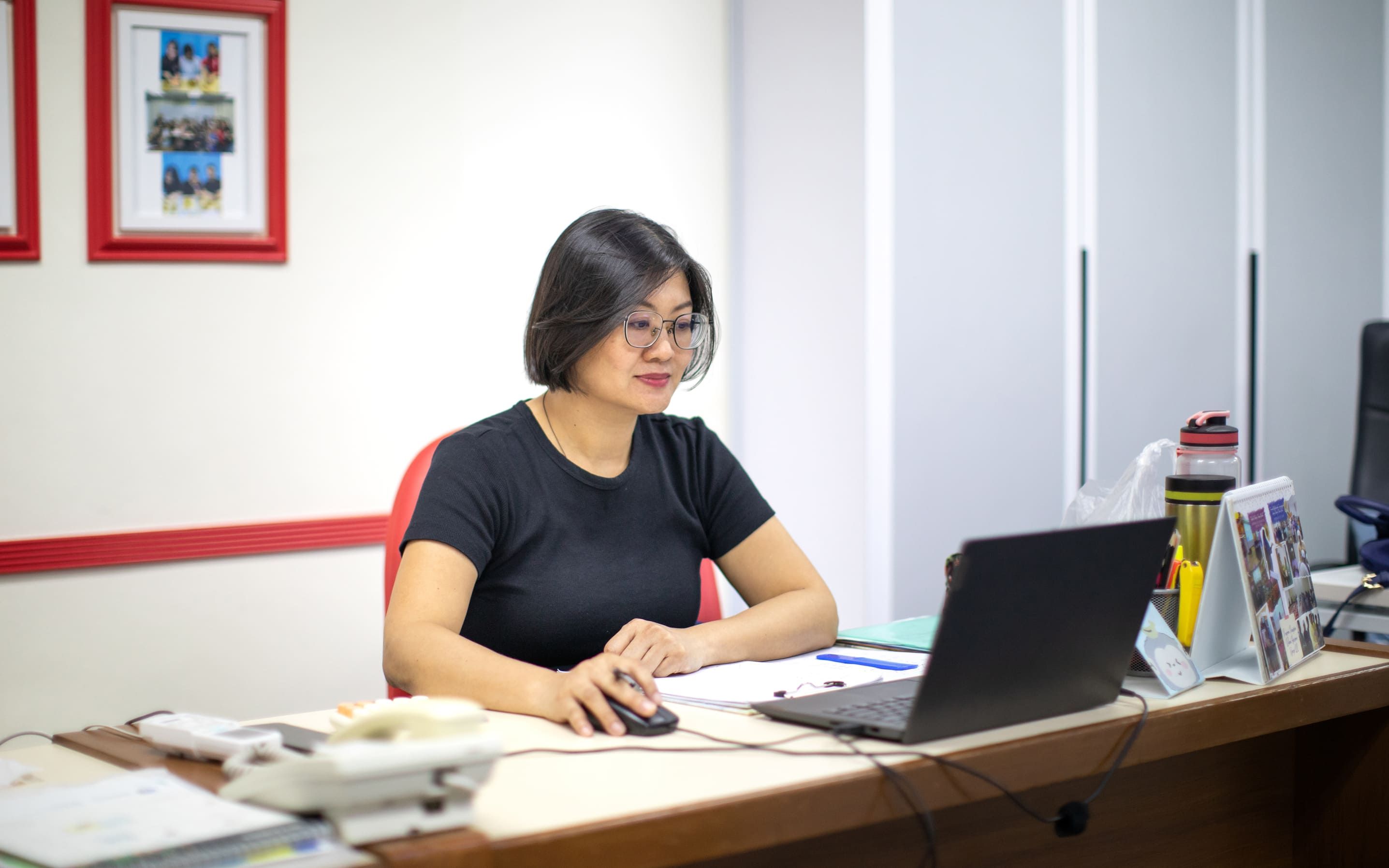 Staff member (Fong) working on laptop